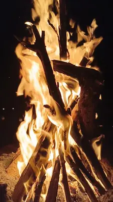 a fire is burning in a fire pit at Stay under millions of stars deep in the desert in El Gouera