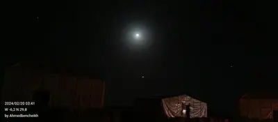 a view of the moon in the night sky at Stay under millions of stars deep in the desert in El Gouera