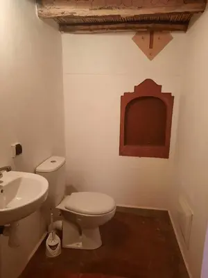 a bathroom with a white toilet and a sink at Gorges View Dades in Tamellalt