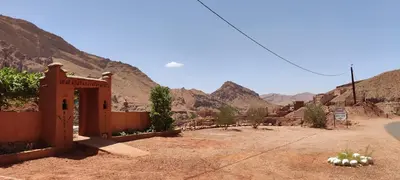 a building in the desert with mountains in the background at Gorges View Dades in Tamellalt