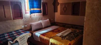 a small bedroom with a bed and a window at Gorges View Dades in Tamellalt