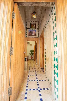 a hallway with a tiled floor in a house at Dar Houda in Fès
