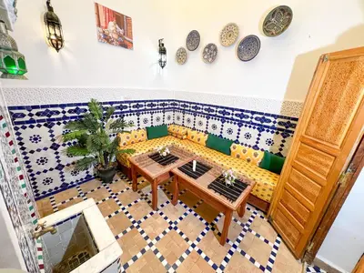 a living room with a couch and a table at Dar Houda in Fès