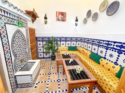 a living room with a couch and a table at Dar Houda in Fès