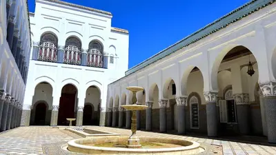 a fountain in the middle of a courtyard in a building at Youssef in Fès