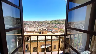 a view of a city from an apartment window at Youssef in Fès