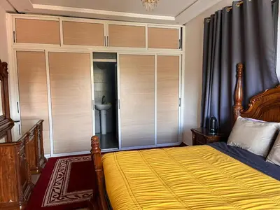 a bedroom with a bed and a large window with blinds at Villa isouktan in Sbiti