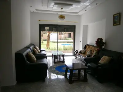a living room with couches and a coffee table at Villa isouktan in Sbiti