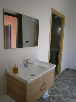 a bathroom with a sink and a mirror at Villa isouktan in Sbiti
