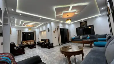 a living room with a couch and chairs and a table at Villa isouktan in Sbiti