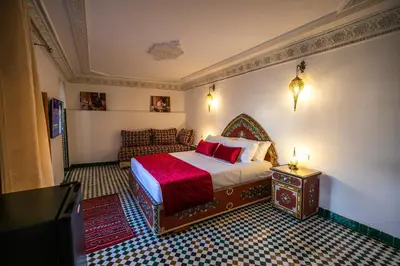 a bedroom with a bed and a couch in a room at Riad Jamal in Fès
