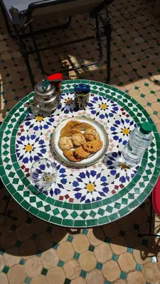 a table with a plate of cookies on top at Riad Jamal in Fès