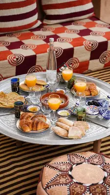 a tray of breakfast foods and orange juice on a table at Riad Jamal in Fès