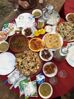 a table topped with lots of different types of food at Riad et Restaurant chez Alilouch in Nkob