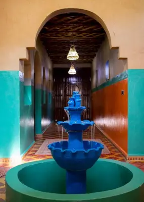 a blue fountain in the middle of a room at Palma Ziz in Aït Athmane