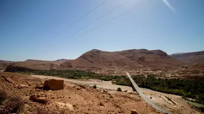 a view of a desert with a river and mountains at Palma Ziz in Aït Athmane