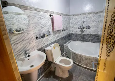 a bathroom with a sink and a toilet and a tub at Palma Ziz in Aït Athmane