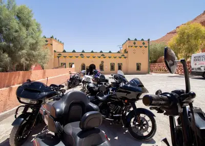 a row of motorcycles parked in front of a building at Palma Ziz in Aït Athmane