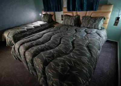 a bedroom with two beds in a room at Palma Ziz in Aït Athmane