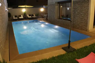 a swimming pool in the middle of a building at Riad Mimosa in Fès
