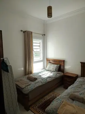 a bedroom with two beds and a window at Heaven of Fes in Fès