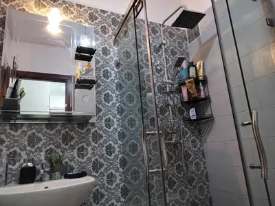 a bathroom with a shower and a sink and a mirror at Heaven of Fes in Fès