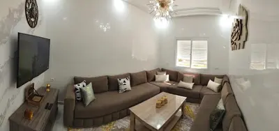 a living room with a couch and a tv at Heaven of Fes in Fès