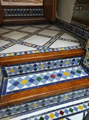 a set of stairs with colorful tiles on them at Riad Averroès in Fès