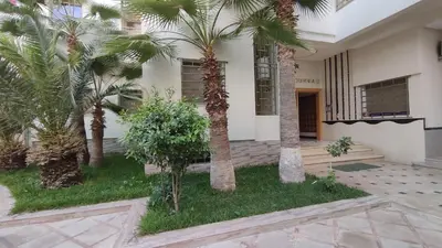 a building with palm trees in the courtyard at Oumnia12 in Fès