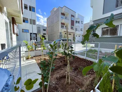 a garden in the middle of a building with plants at شقه معاصره ب لمسة مغربيه في فاس in Fès