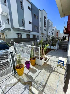 a balcony with potted plants and a building at شقه معاصره ب لمسة مغربيه في فاس in Fès