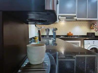 a kitchen with a coffee cup on a counter at شقه معاصره ب لمسة مغربيه في فاس in Fès