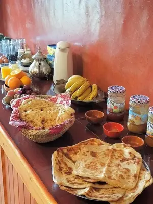 a table topped with pies and fruit on a counter at KASBAH ALTAÏR in Kalaat MGouna