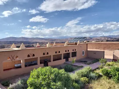 a building in the desert with a solar roof at KASBAH ALTAÏR in Kalaat MGouna