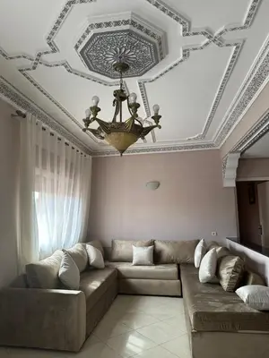 a living room with a couch and a ceiling at Résidence Bab El Janoub in Ouarzazate