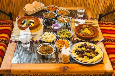 a table with many plates of food on it at Riad Batha in Fès