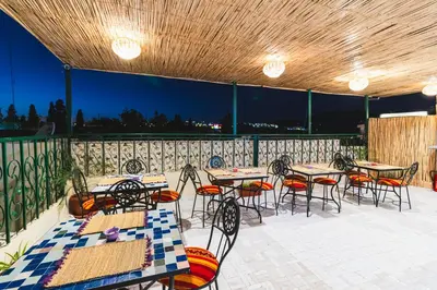 a group of tables and chairs on a patio at Riad Batha in Fès