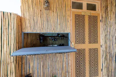 a wooden wall with a shelf next to a door at Riad Batha in Fès