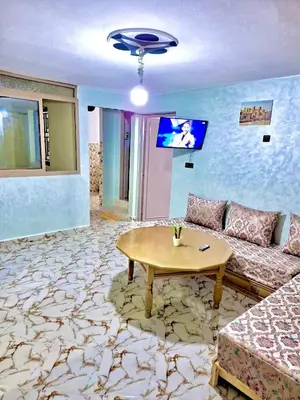 a living room with a couch and a table at Résidence SEHRAWILOCATION in Er Rachidia