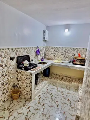 a kitchen with a sink and a counter in a room at Résidence SEHRAWILOCATION in Er Rachidia