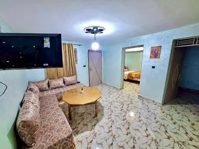 a living room with a couch and a table at Résidence SEHRAWILOCATION in Er Rachidia