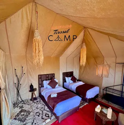 a bedroom with two beds in a tent at Merzouga Tirssal Camp in Merzouga