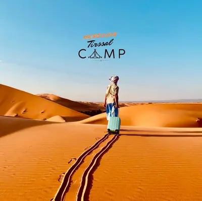 a man standing on top of a desert at Merzouga Tirssal Camp in Merzouga