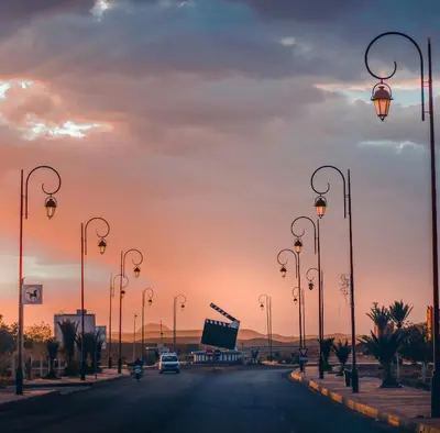 a street with street lights on the side of a road at WARZAZAT Hostel in Ouarzazate