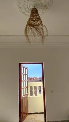 a ceiling fan and a mirror in a room at WARZAZAT Hostel in Ouarzazate