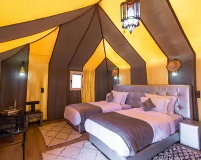 a bedroom with two beds in a room at Sahara Berber Luxury Camp in Merzouga