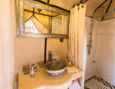 a bathroom with a sink and a mirror at Sahara Berber Luxury Camp in Merzouga