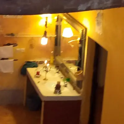 a bathroom with a sink and a mirror at Dar adiafa dar asalam in Aït Ben Haddou
