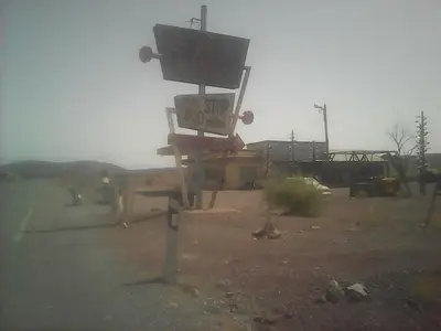 a sign in the middle of a parking lot at Dar adiafa dar asalam in Aït Ben Haddou