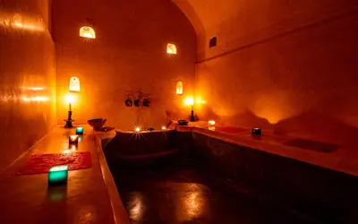 a room with a bath tub with candles in it at Dar Biona in Marrakech